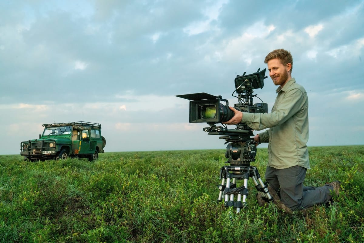 Sebastian Solberg filming a documentary on a tripod in Tanzania