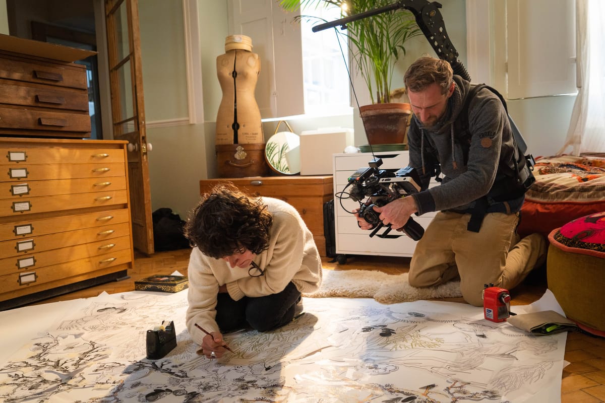 Filmmaker capturing a documentary sequence with one camera