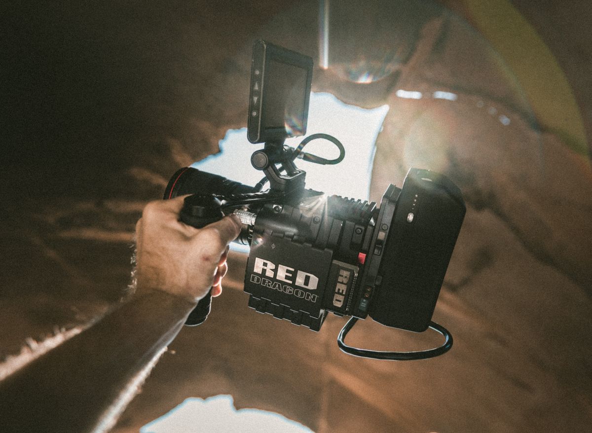 Documentary filmmaker shooting outdoors with natural light
