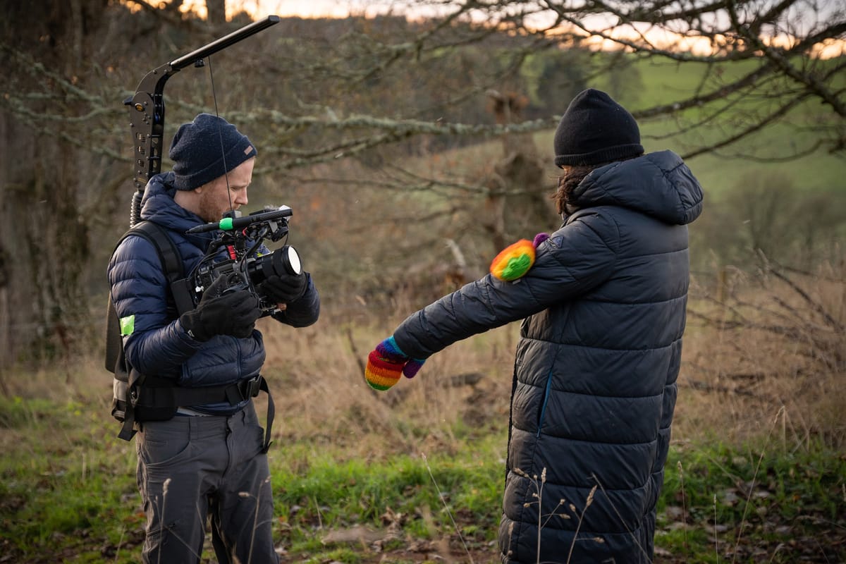 Filmmaker adjusting fixed focus for a static documentary shot