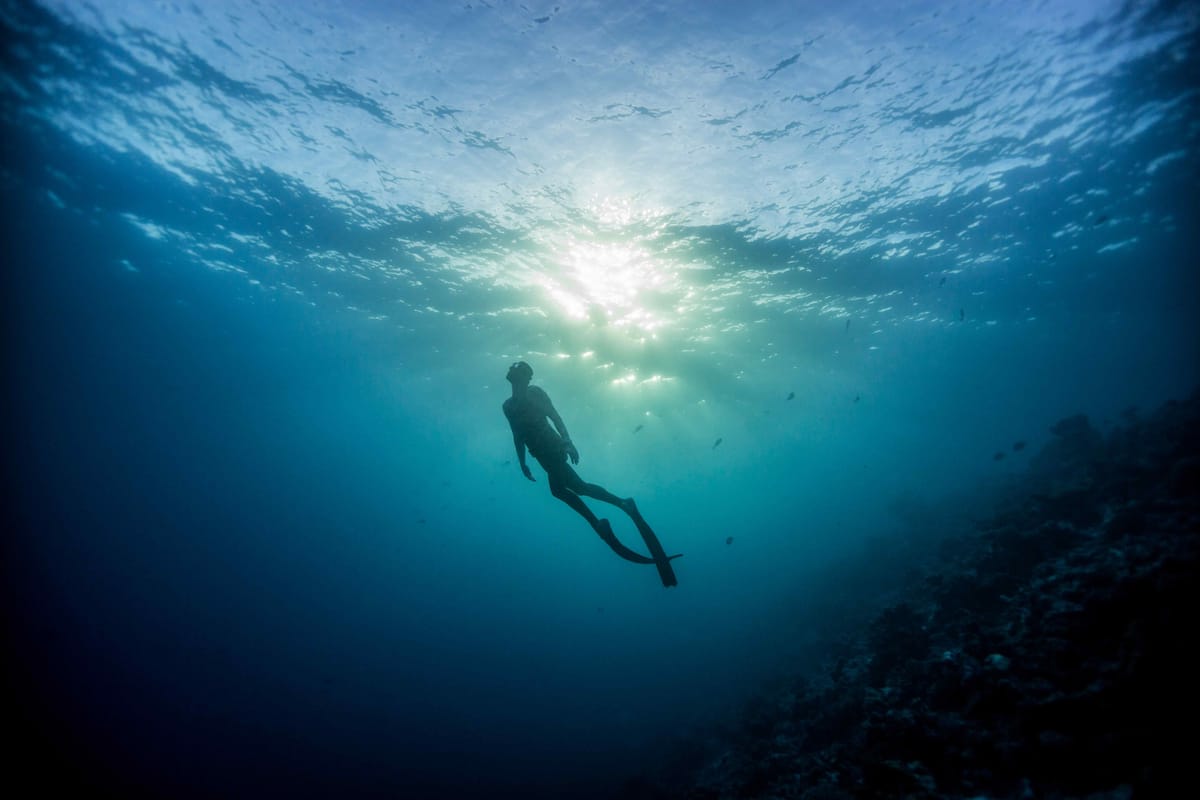 Freediver underwater on location in the Maldives
