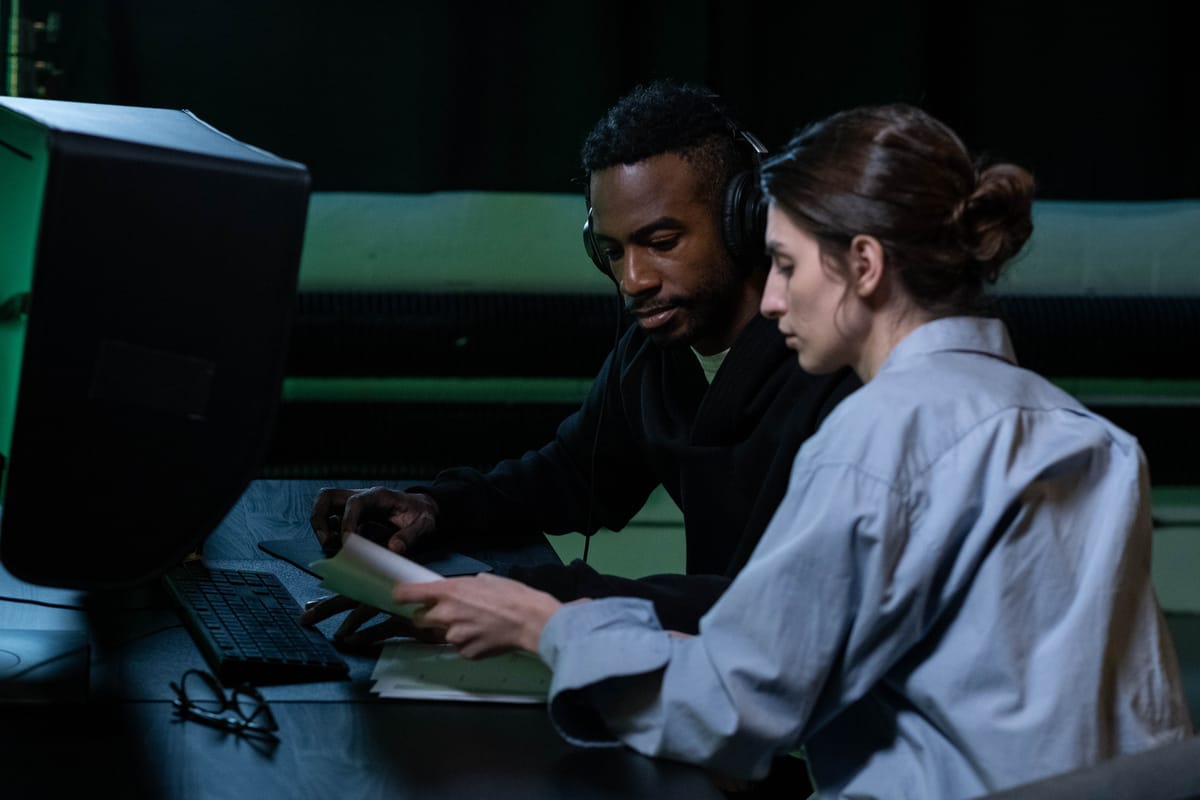 Documentary filmmaker reviewing interview transcripts on screen