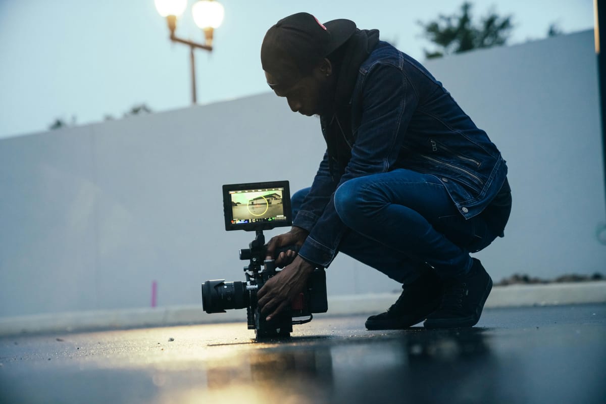 Filmmaker setting up a documentary scene outdoors