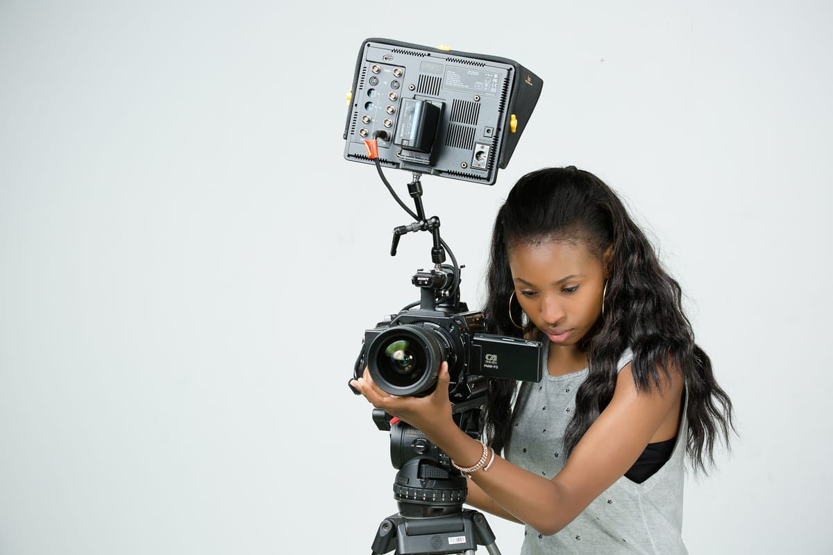 Solo filmmaker using manual focus on a documentary camera