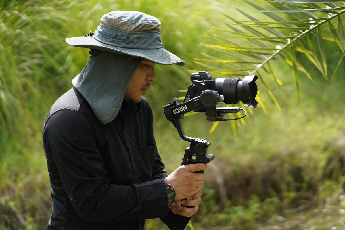 Filmmaker using cinematic gimbal techniques outdoors