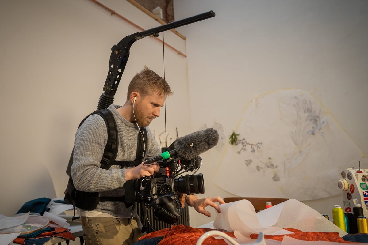 Filmmaker working with documentary camera gear on location