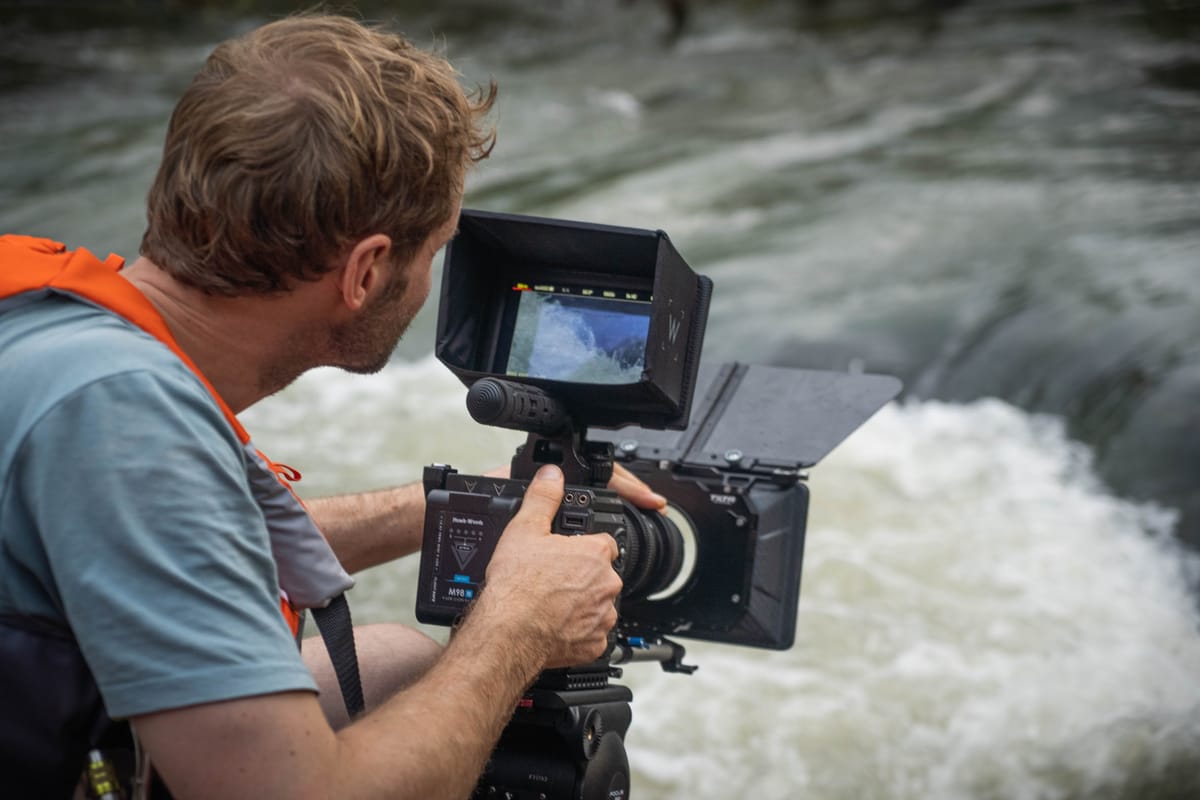 Filmmaker capturing high-quality documentary footage outdoors