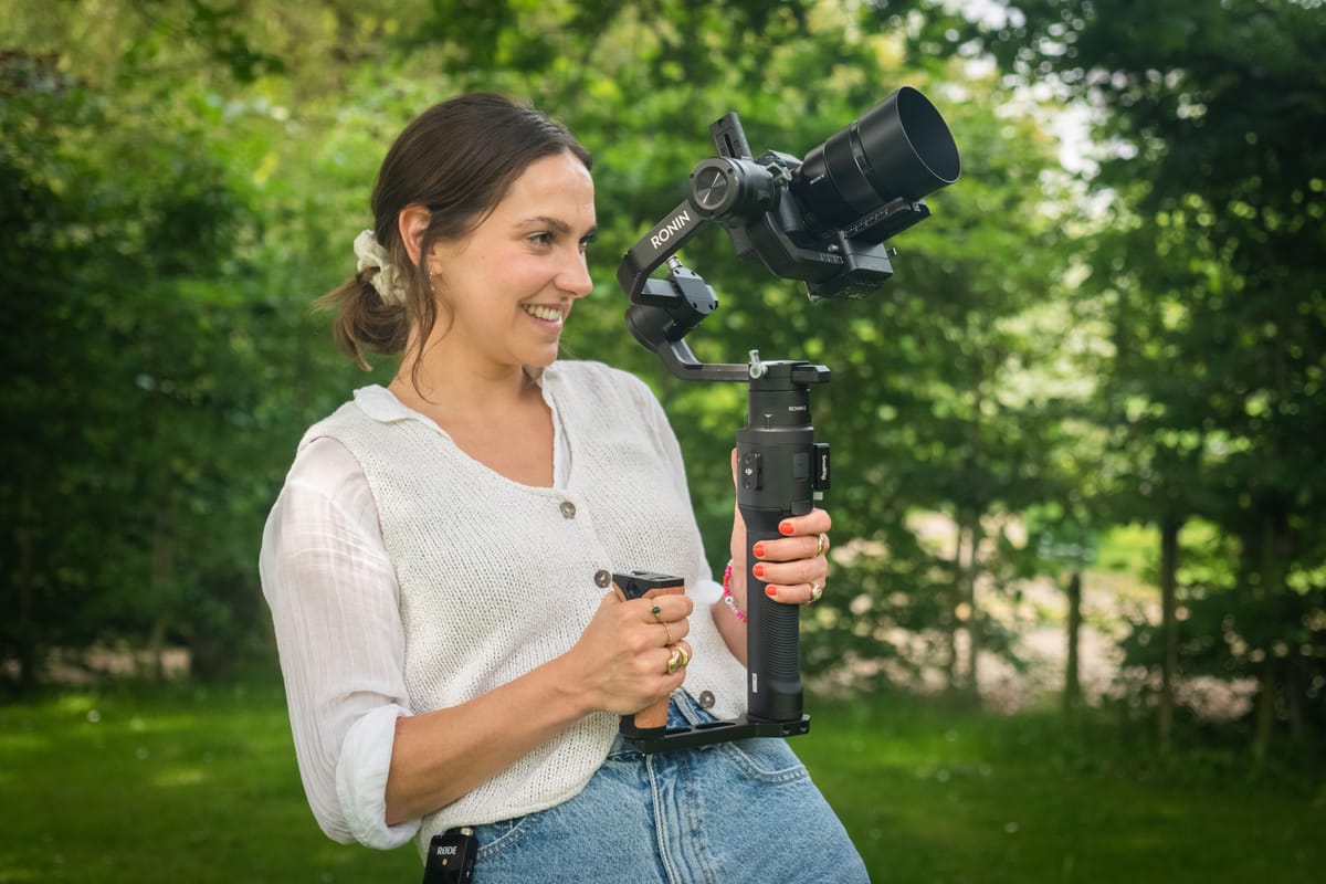 Solo documentary filmmaker shooting in the field with a camera on a tripod