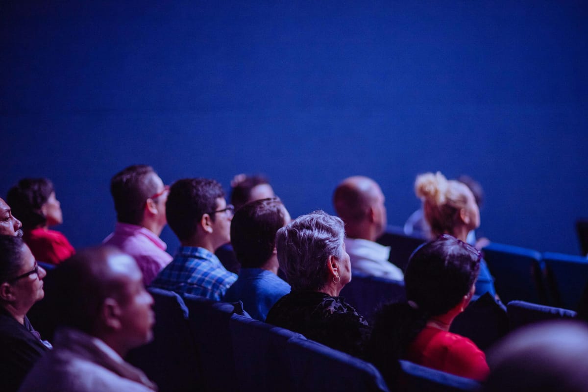 Documentary film festival screening with audience and filmmakers in attendance