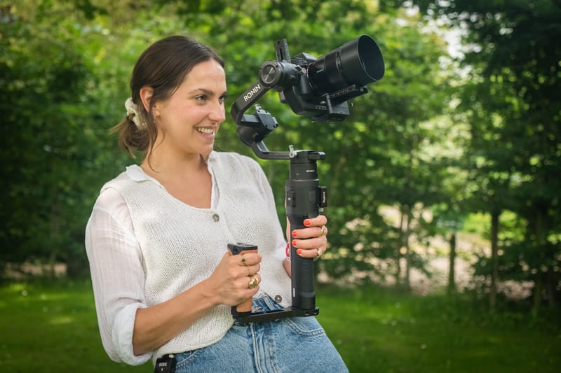 A first-time filmmaker filming with a small camera on a gimbal