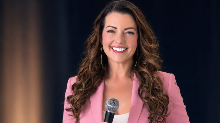 Jaimie Abbott smiling with a microphone