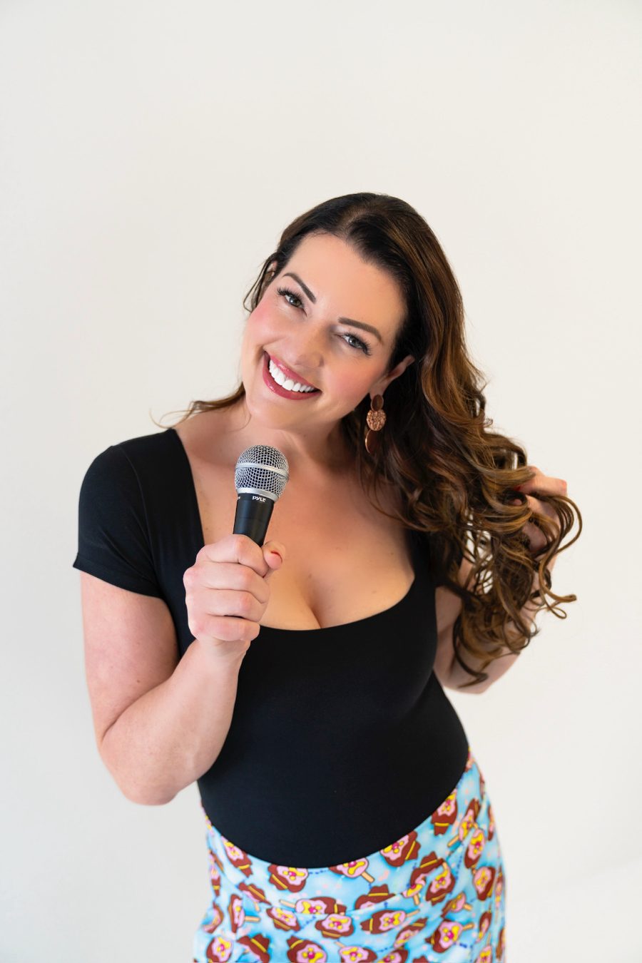 Jaimie Abbott smiling with a microphone