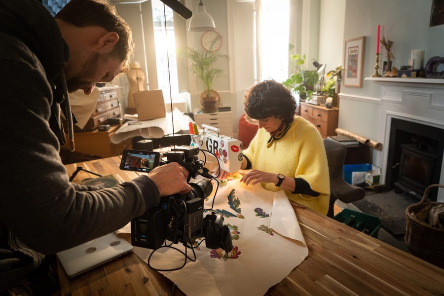 Sebastian filming an artist at work in her home