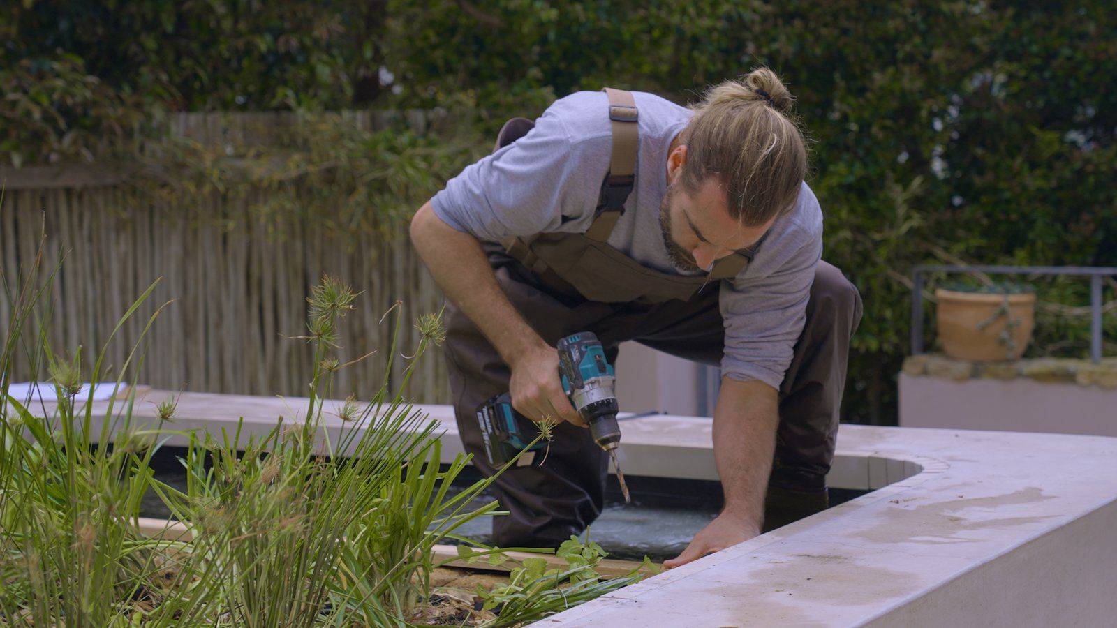 Andy Jamieson working at the edge of a natural pool