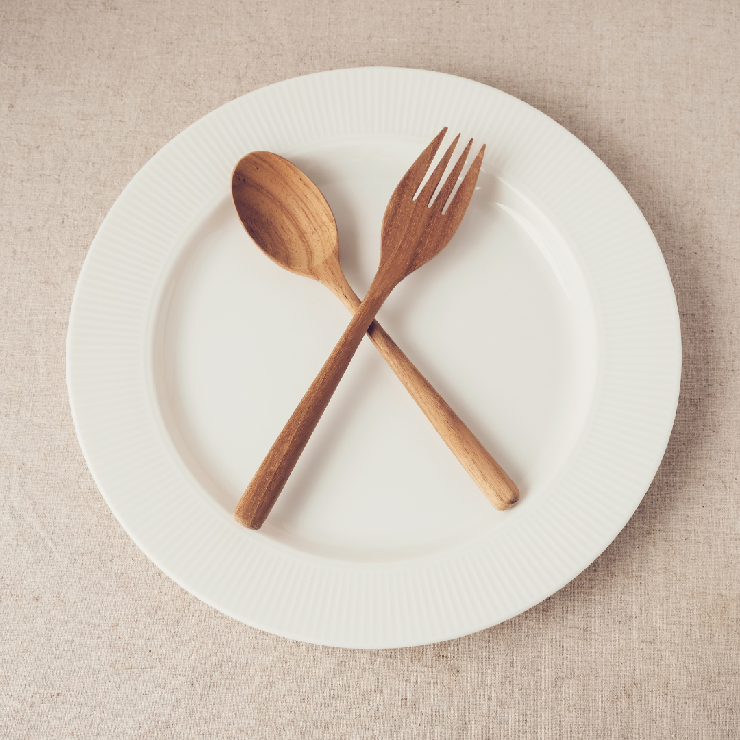 wooden fork and spoon on a white plate