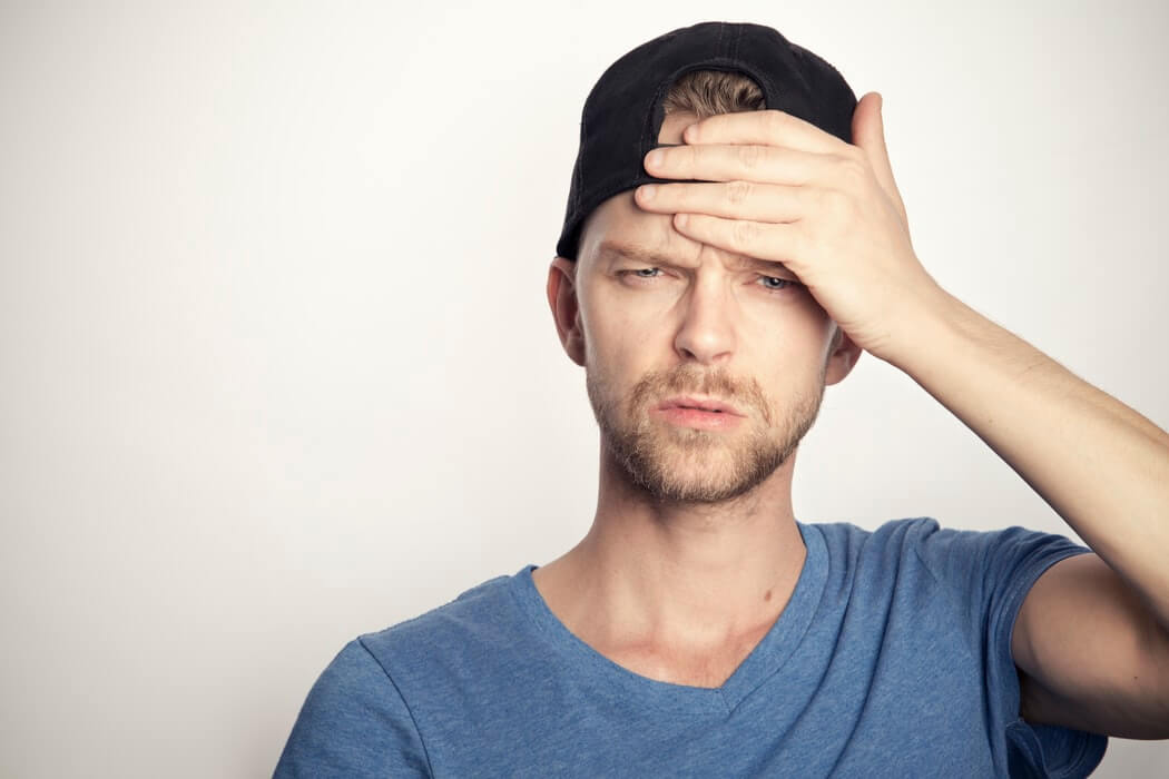 Incredulous man protecting his head