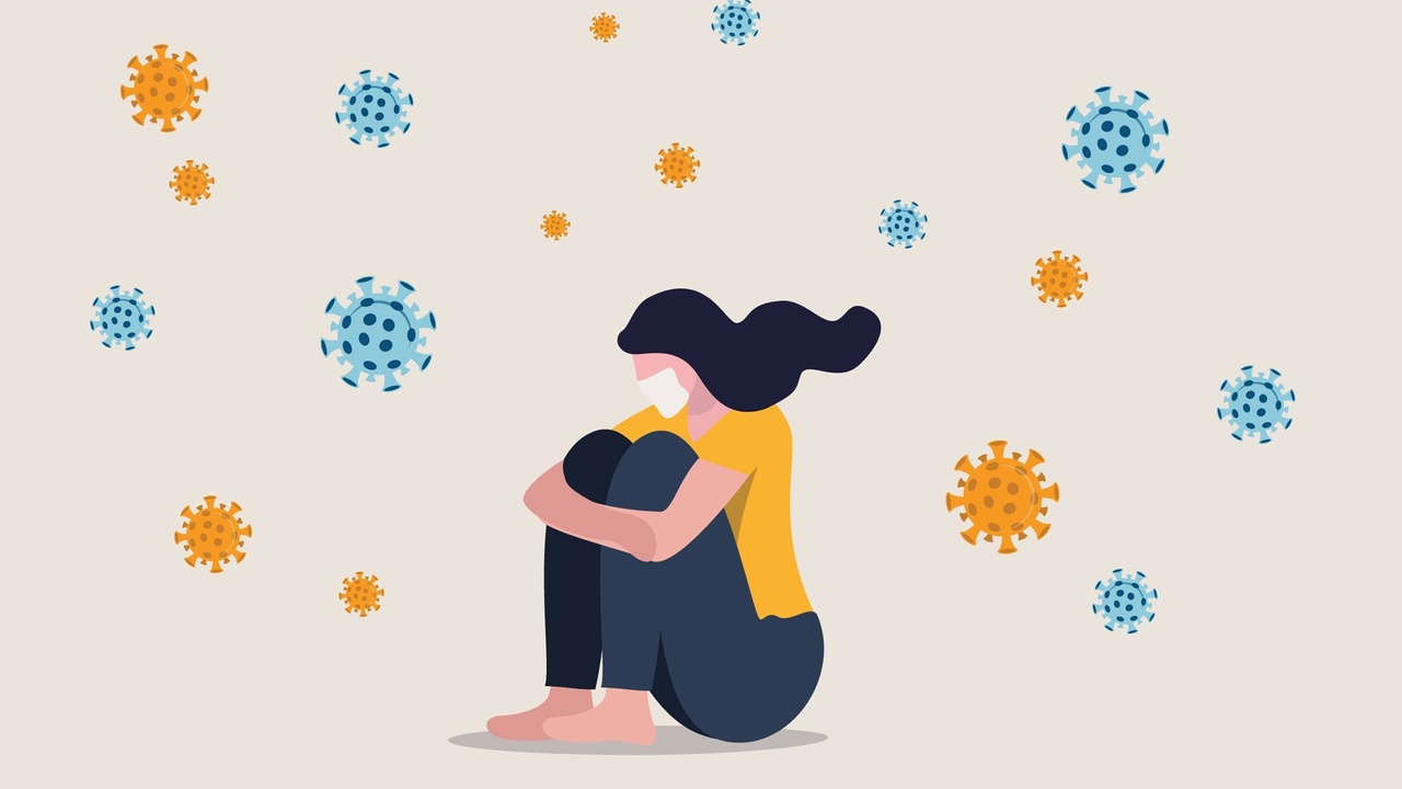 cartoon woman with mask on her face sitting huddled up amongst virus particles