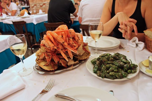 A seafood platter and pimientos de Padrón on a table at Ribeira do Miño, Madrid seafood restaurant