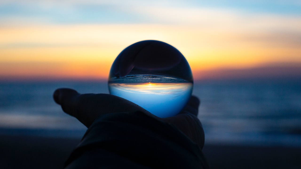 Person holding a glass globe