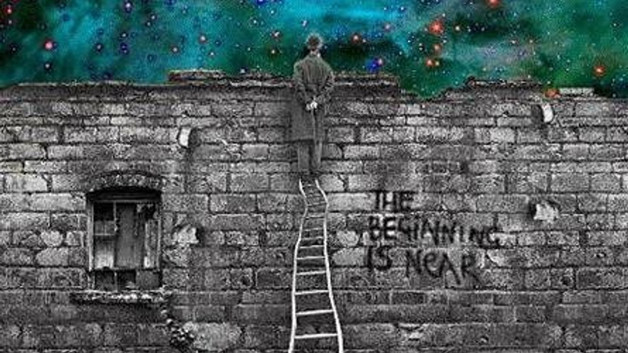 SOLAR ECLIPSE IN VIRGO & LUNAR ECLIPSE IN PISCES: SEPTEMBER 2016 A man standing on a winding ladder against a wall with a boarded up window and graffiti which says The Beginning is Near. This is in black and white. The man is looking over a wall into a colourful comos sky 