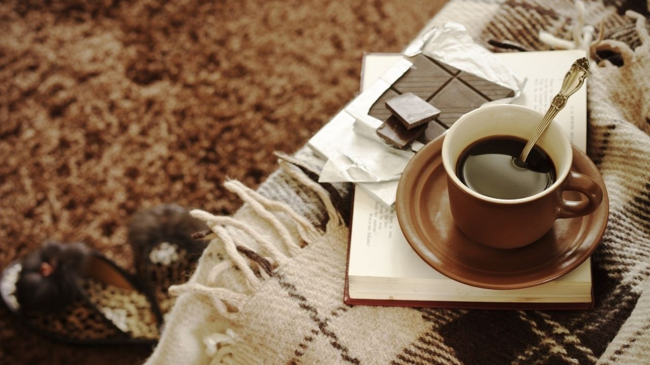 Coffee and chocolate a book- to signify comfort culture 