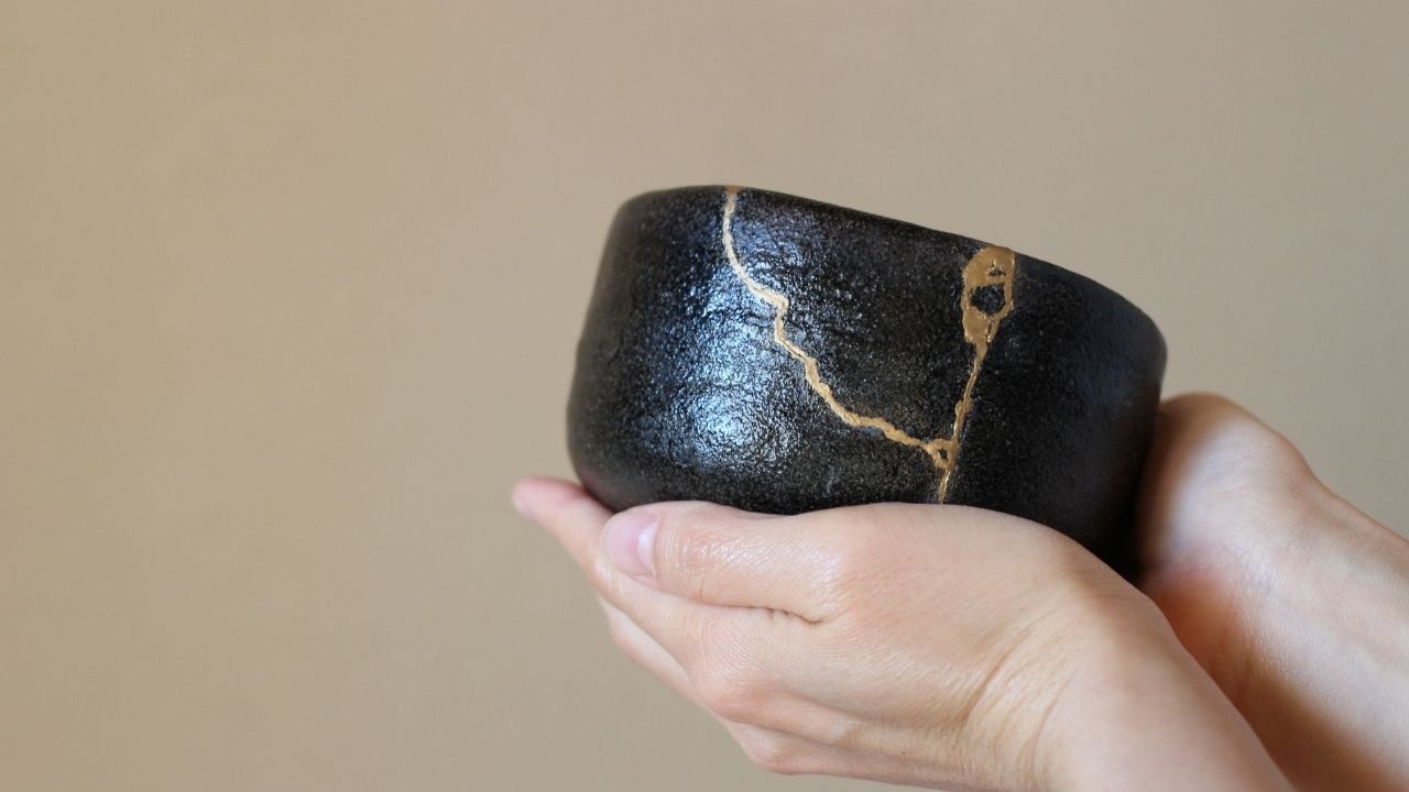 Kintsugi bowl held in two hands