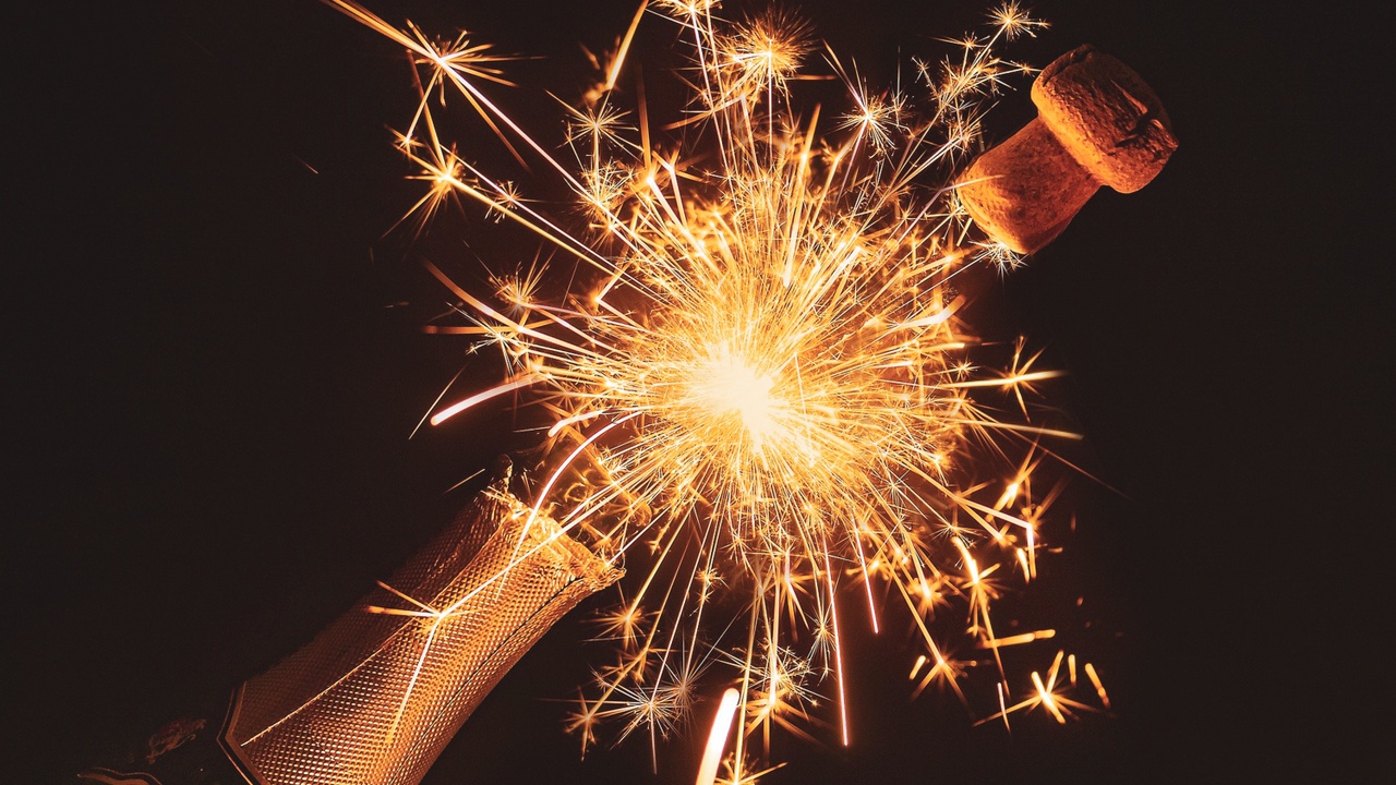 champagne bottle popping with sparkler