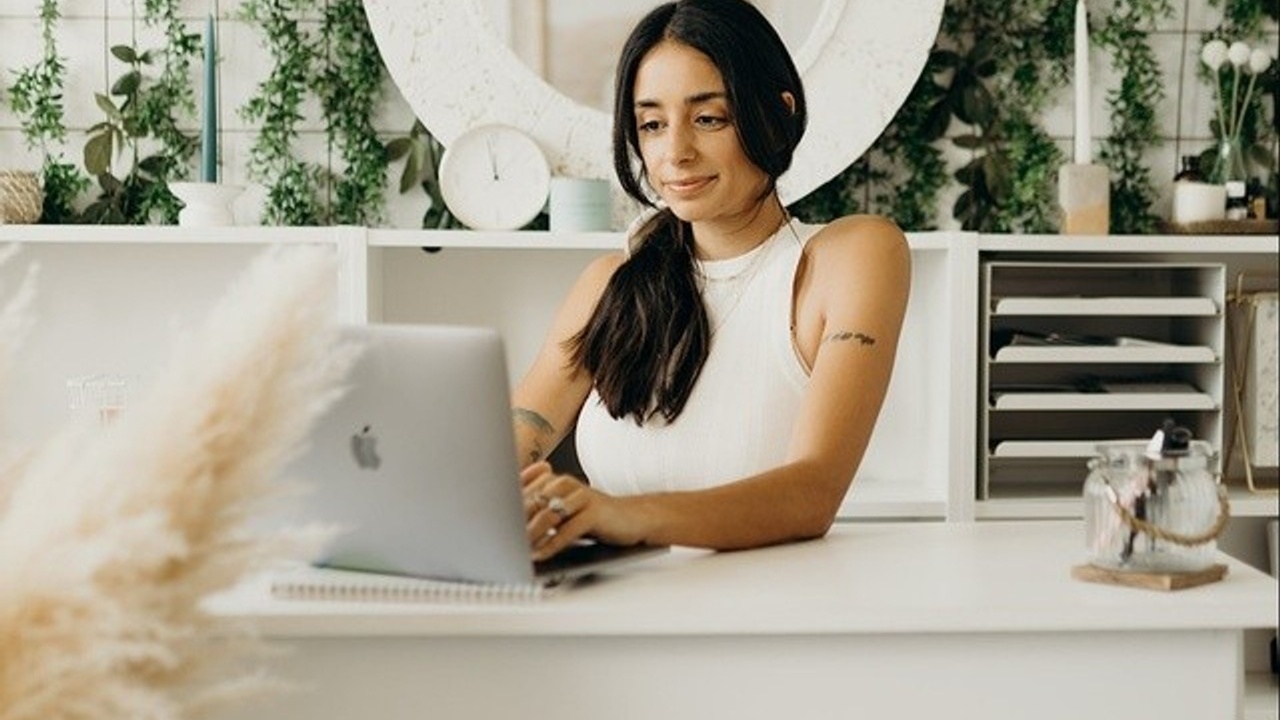 Brittany Piper sitting at her work desk on a computer.