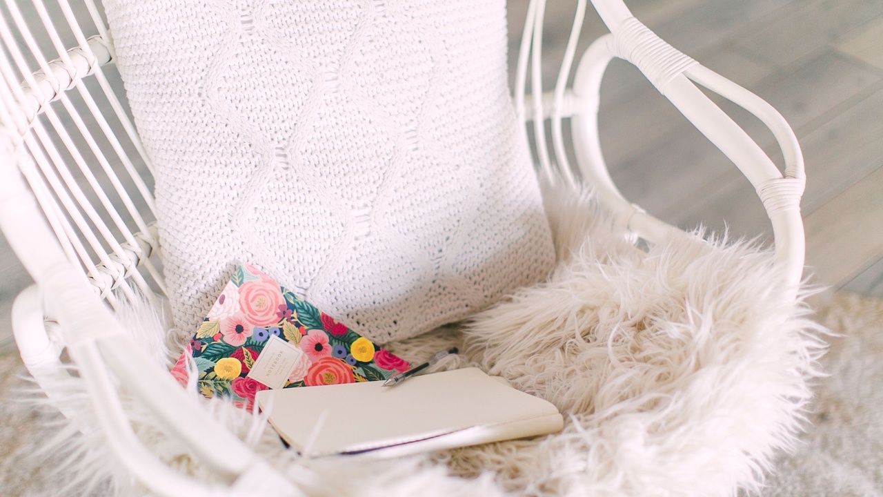 white cosy chair with journal