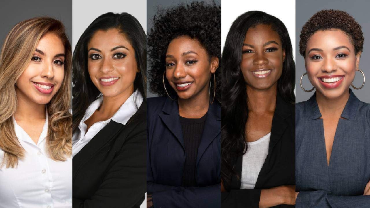 five professionally dressed Black women of different shades of brown