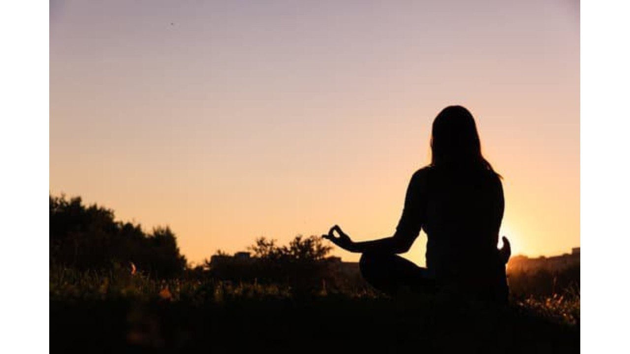 Woman at sunset yoga position