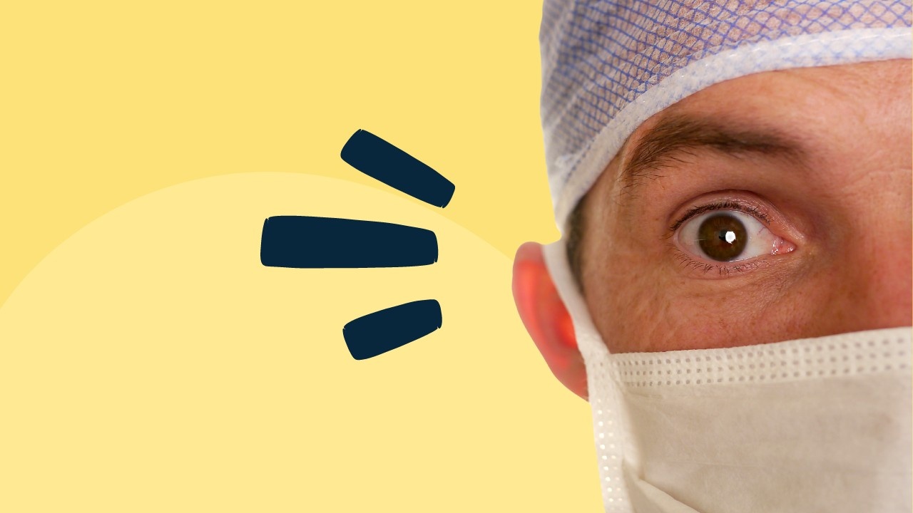 Close-up of a doctor's eye in surgical cap and mask with an exclamation mark on a yellow background.