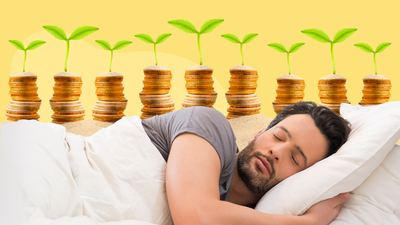 A man sleeping peacefully with sprouting plants on rising stacks of coins against a yellow backdrop.