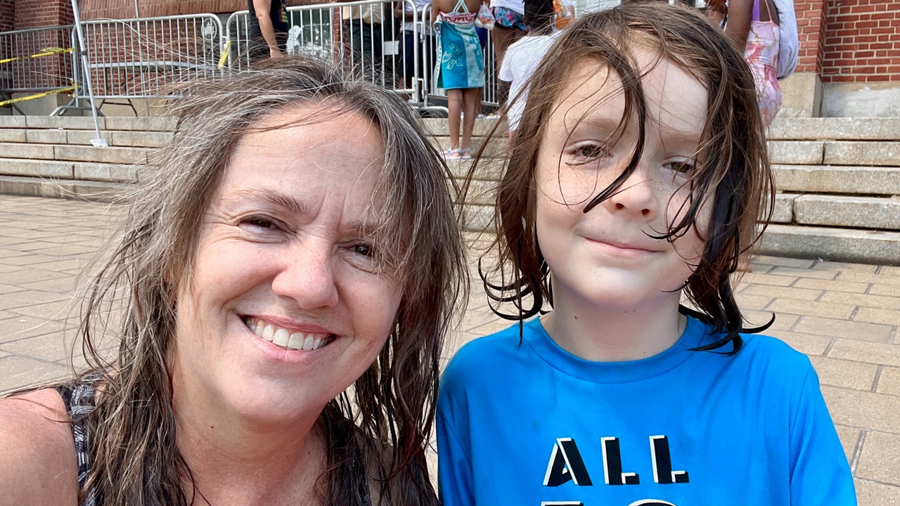 Kate Lynch and her son with messy hair after swimming.