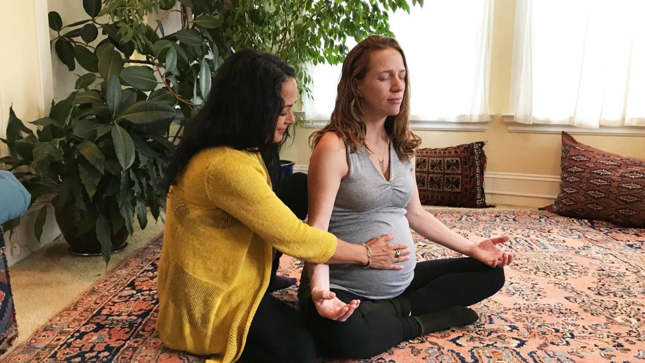 A Breema practitioner giving Breema bodywork to a pregnant recipient.