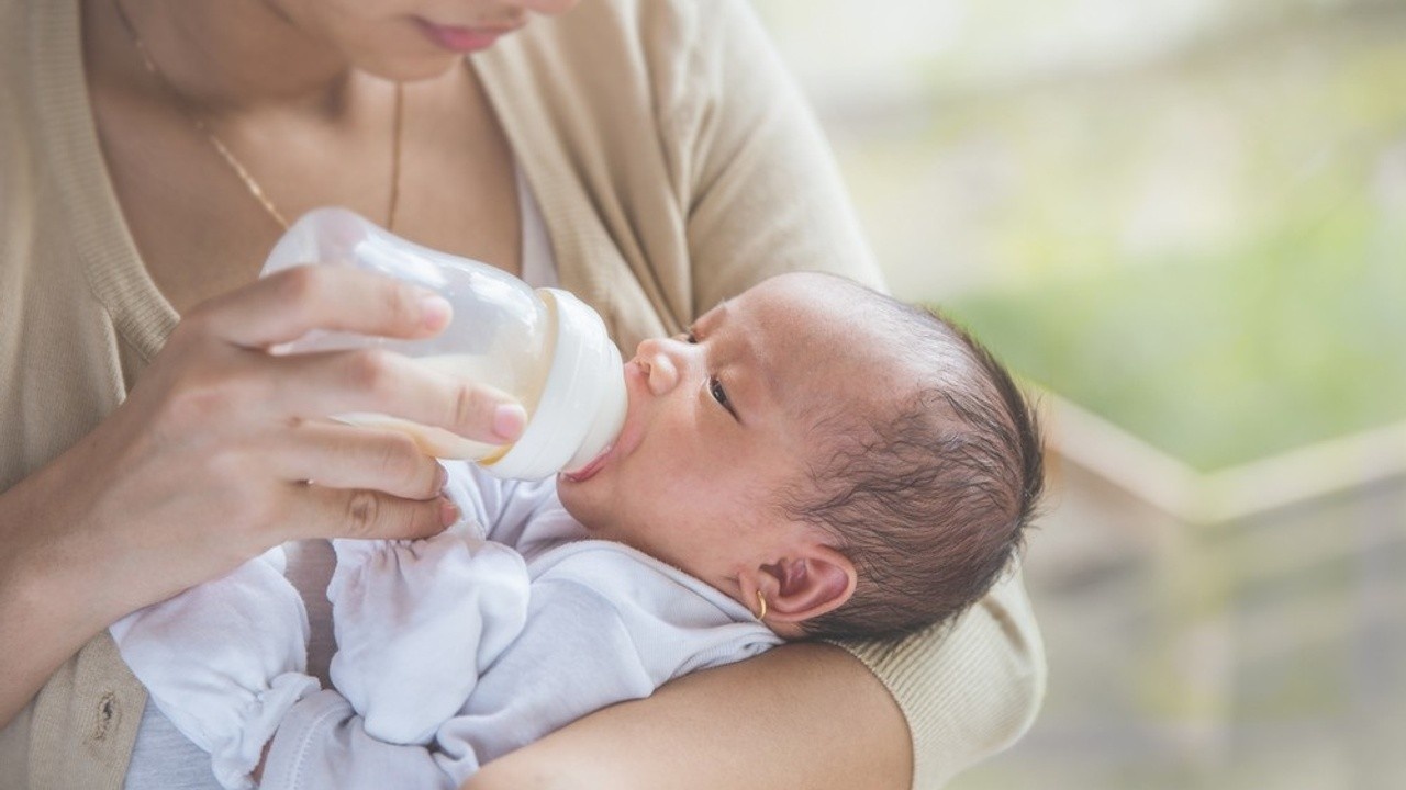 Baby chewing on store nipple of bottle