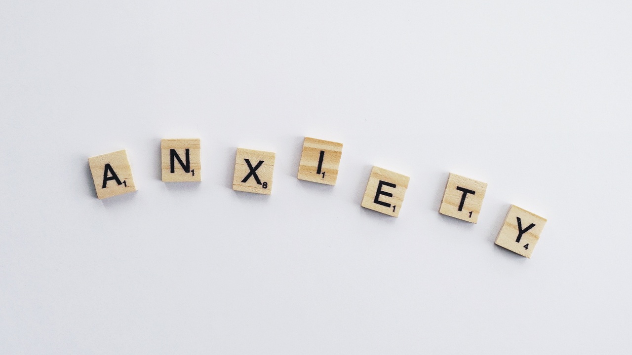 scrabble letters spelling out the word anxiety