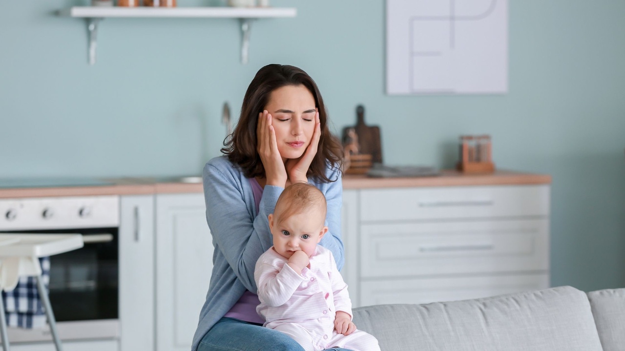 New mother with depression sitting with her baby