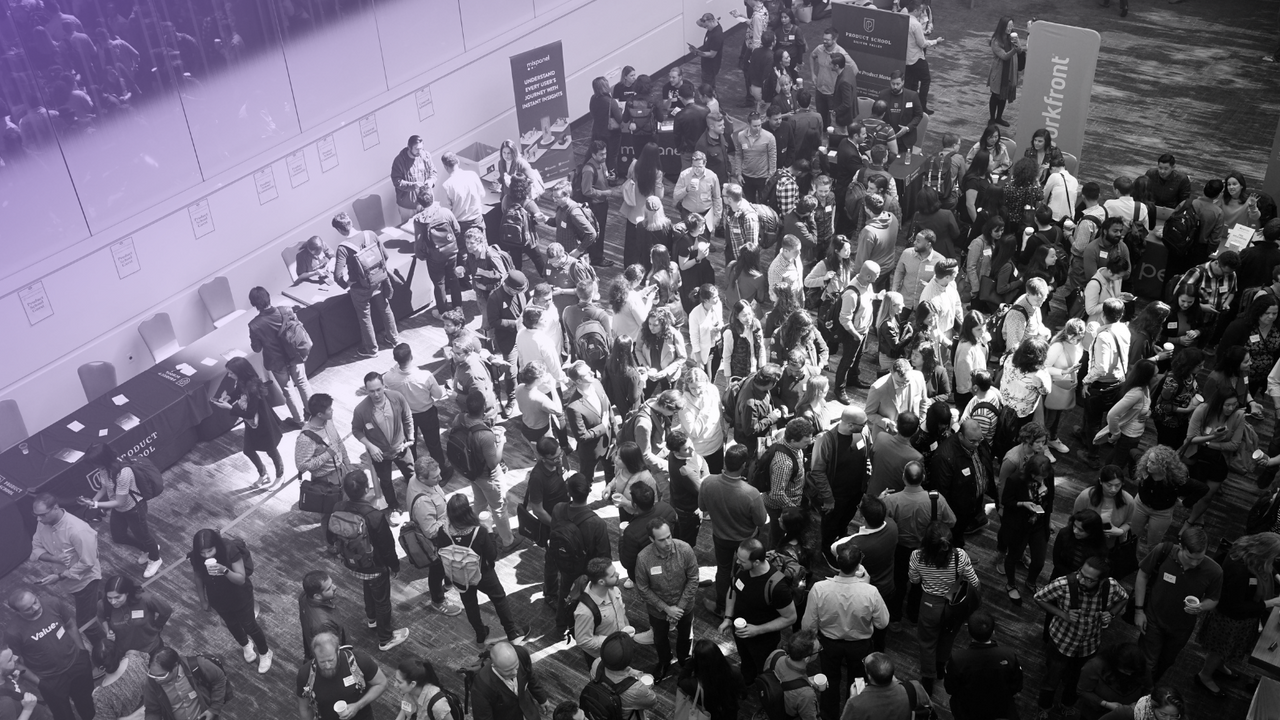 A crowd of about sixty people walking and talking with each other.