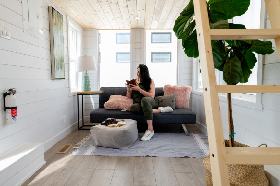 woman in the seating area of a tiny house