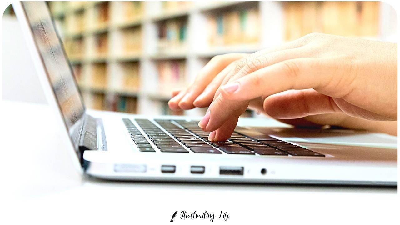 Hands typing on a laptop keyboard.