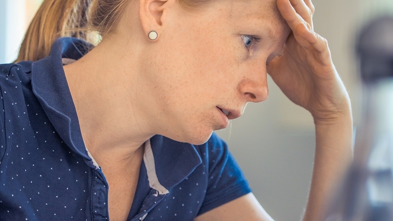 A stressed woman stares at her laptop holding her forehead by Pexels of Pixabay