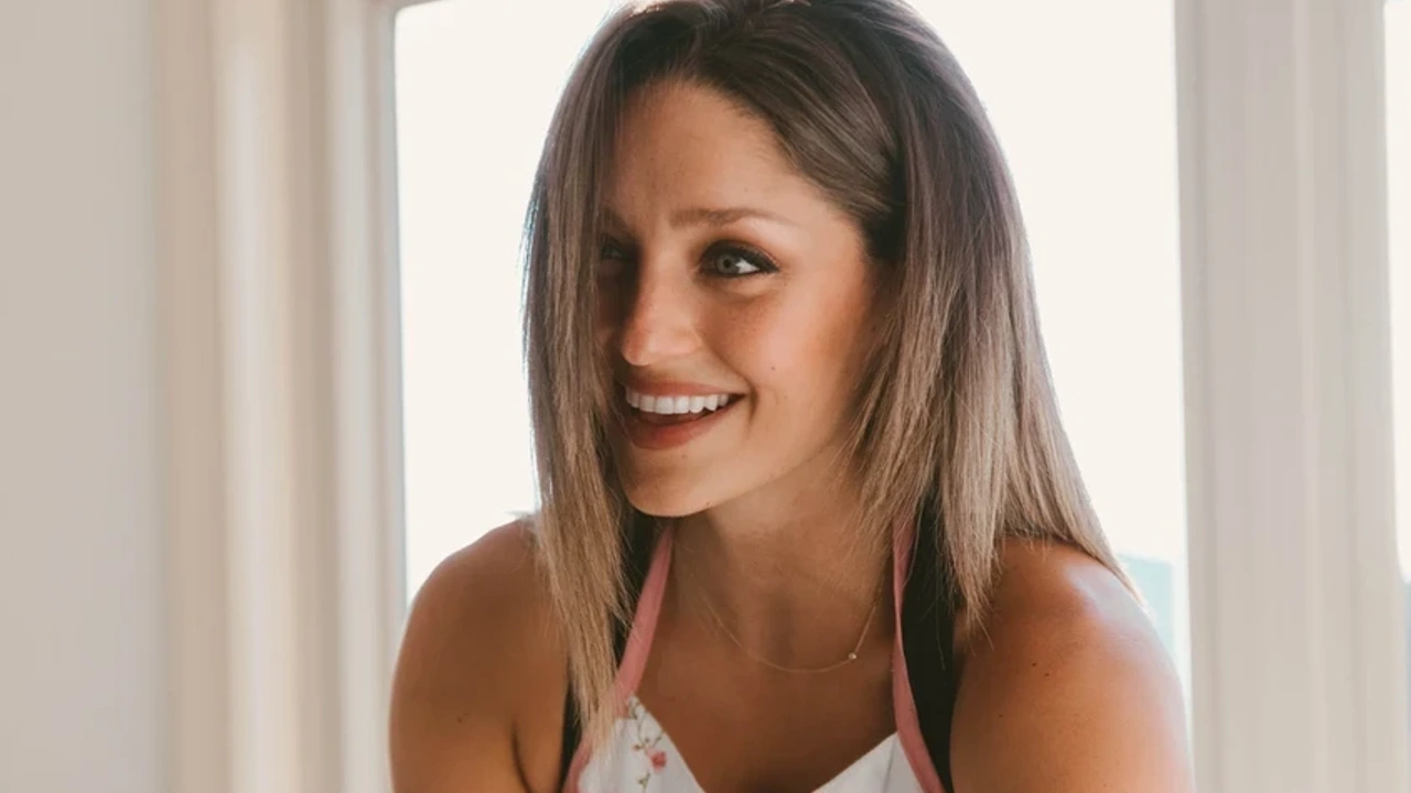 Lindsay smiling in front of a window