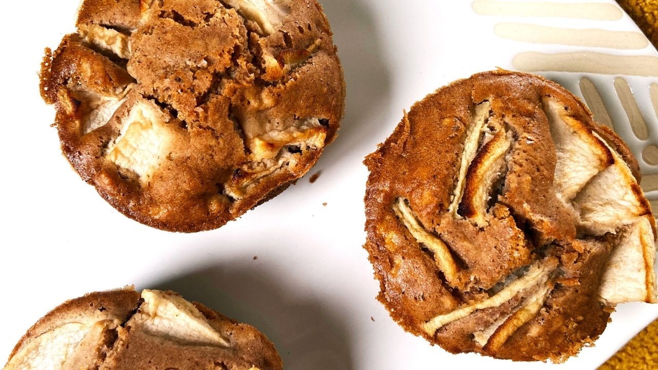 Three Apple Buckwheat Muffins on a white plate.