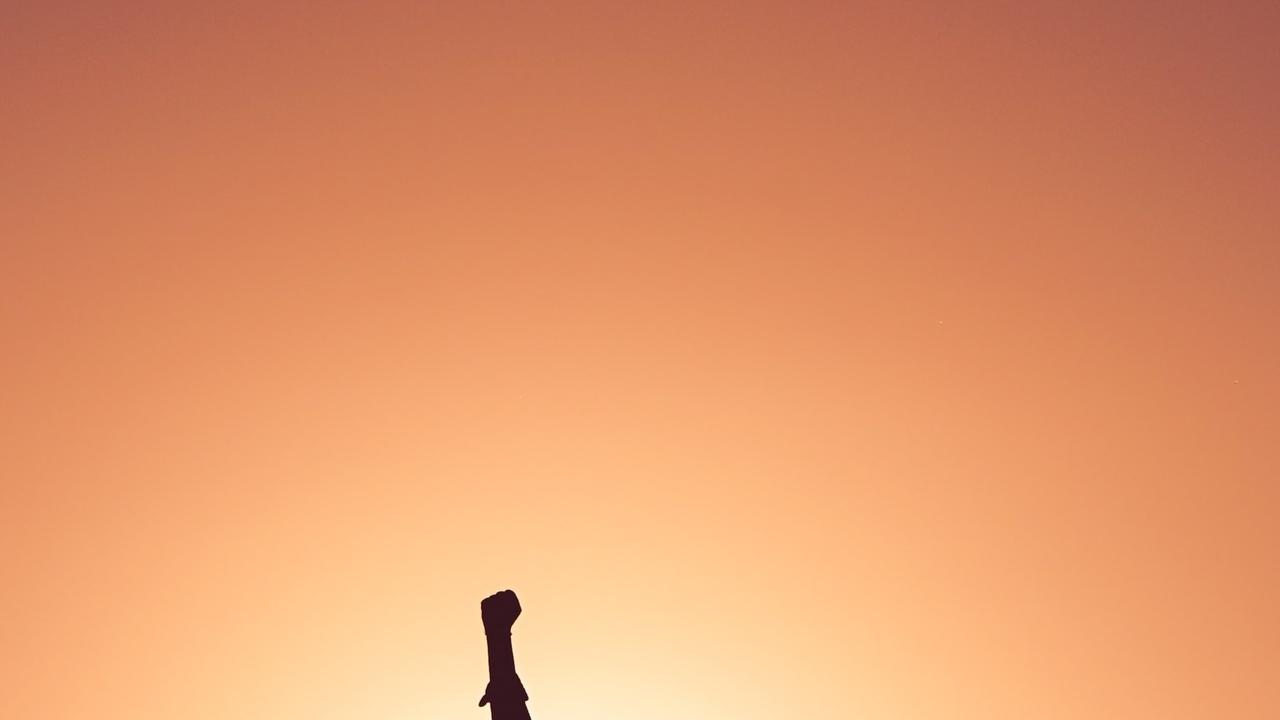 Women raising her fist into the air confidently