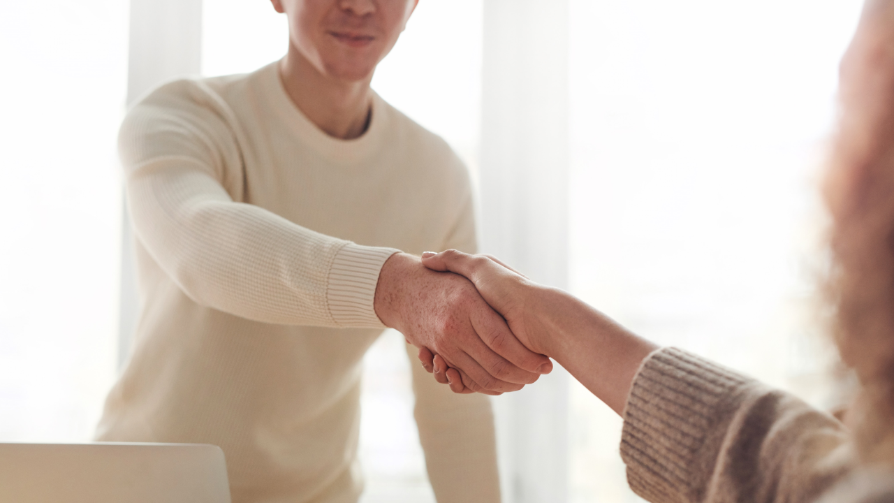 man shaking hands with a woman