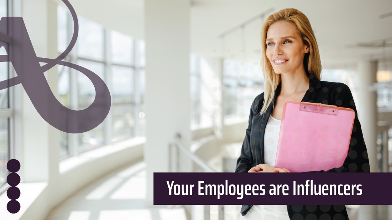 A woman holding a clipboard stands in front of aramp inside an office. The AVRO Creative logo is next to the image. The text reads, Your employees are influencers.