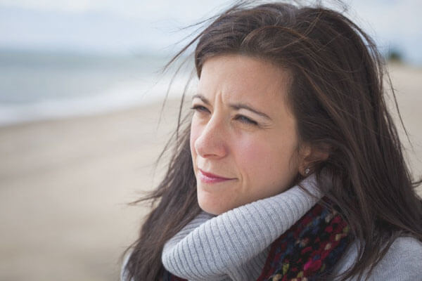  a woman reflecting on herself at the ocean