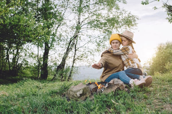 mother and daughter beside a campfile to celebrate the wheel of the year holyday