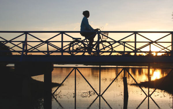 woman biking on a bridge choosing her level of intimacy in relationships